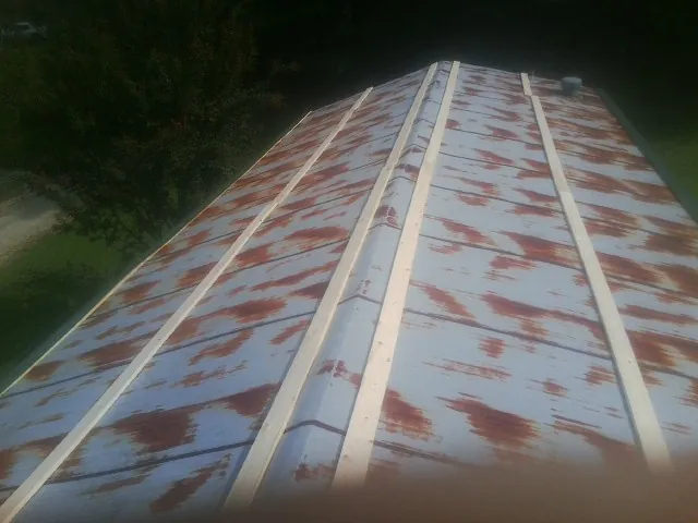 Rusted metal roof panels with new wood purlins before replacement — Storm Damage Roof Repair in Ellwood City by Roofing Brothers