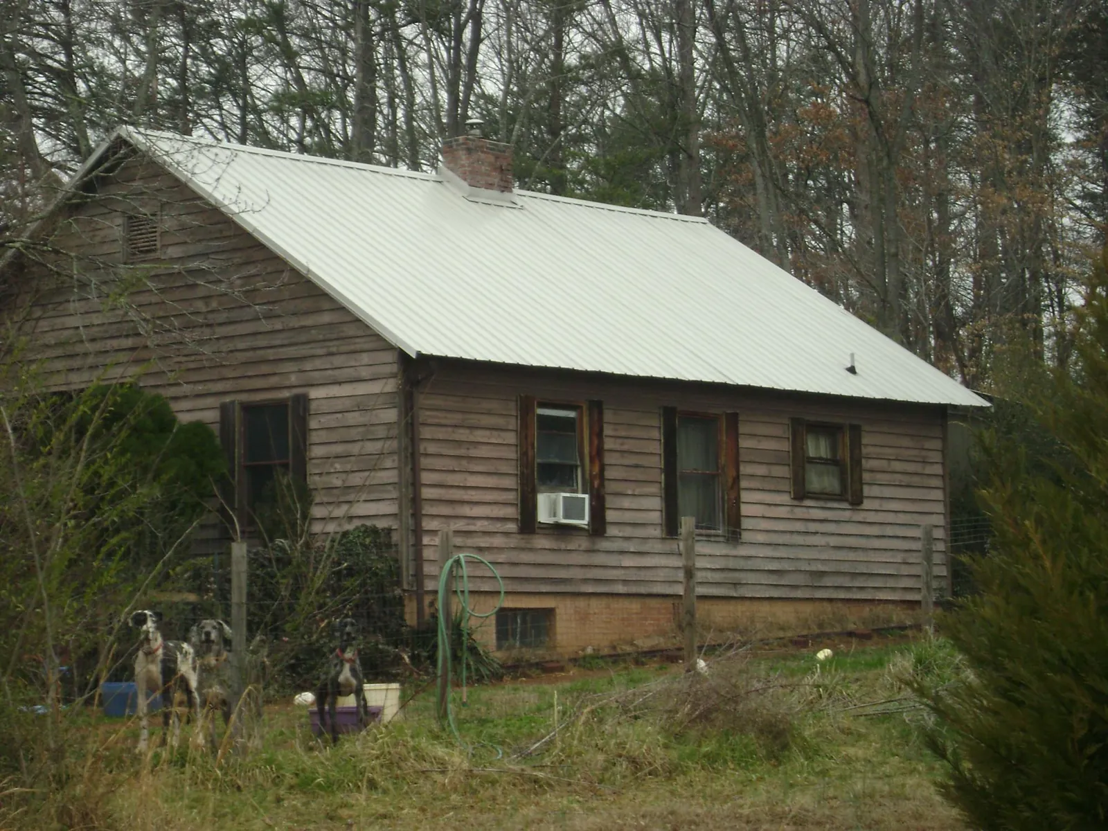 White metal roof on an old wood sided farmhouse, from a Asphalt Shingle Roof Repair job in Ellwood City